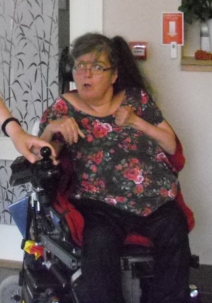 En kvinna i rullstol med glasögon